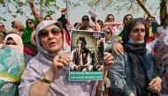 (Files) Pakistan's former prime minister Imran Khan's supporters protest outside the court in Islamabad on June 27, 2024. (Photo by Farooq Naeem / AFP)
