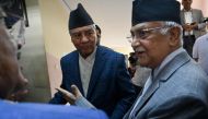 Former prime minister or Nepali Congress president Sher Bahadur Deuba (centre) talks with Communist Party Nepal-Union Marxist Leninist (CPN-UML) chairman KP Sharma Oli (R) as he arrives to attend the photo exhibition of late former PM Girja Prasad Koirala in Kathmandu on July 2, 2024. (Photo by Prakash Mathema / AFP)