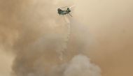 A firefighting helicopter performs a water drop as the Lake Fire burns in Los Padres National Forest with evacuation warnings in the area on July 6, 2024 near Los Olivos, California. (Photo by MARIO TAMA / GETTY IMAGES NORTH AMERICA / Getty Images via AFP)
