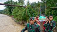 Members of a rescue team carry a survivor of the landslide at Tulabolo village in Bone Bolango Regency of the Gorontalo Province on July 8, 2024. (Photo by Didot / AFP)
 