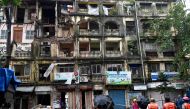 Rescue personnel gather outside the partially collapsed Rubinissa Manzil, a residential building in Mumbai on July 20, 2024. (Photo by Sujit Jaiswal / AFP)