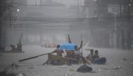 Rescuers paddle their boats along a flooded street in Manila on July 24, 2024 amid heavy rains brought by Typhoon Gaemi. (Photo by Ted Aljibe / AFP)

