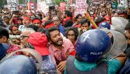 Cultural activists and members of civil society clash with police personnel during a song march for victims who were killed during the recent nationwide student protests in Dhaka on July 30, 2024. (Photo by Munir Uz Zaman / AFP)