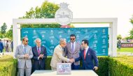 Qatar Olympic Committee President H E Sheikh Joaan bin Hamad Al Thani looks on as Qatar Tourism Chairman Saad bin Ali Al Kharji (right) shakes hands with the Duke of Richmond, Chairman of Goodwood Racecourse during the sponsorship signing ceremony. 