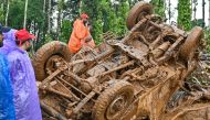 Rescue workers check a damaged vehicle after the landslides in Wayanad on August 1, 2024. Photo by Idrees MOHAMMED / AFP.
