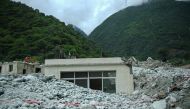 A partially buried building is pictured a day after a landslide in Kangding, in China痴 southwest Sichuan province on August 4, 2024. (Photo by CNS / CNS / AFP)