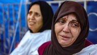 An injured woman reacts after identifying a member of her family among the dead at the al-Maamadani hospital, following an Israeli strike that killed more than 90 people on a school sheltering displaced Palestinians in Gaza City on August 10, 2024. Photo by Omar AL-QATTAA / AFP