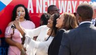 US Vice President and Democratic presidential candidate Kamala Harris takes photos with supporters upon arrival at Savannah/Hilton Head International Airport in Savannah, Georgia, August 28, 2024, as she travels for a 2-day campaign bus tour. (Photo by Saul Loeb / AFP)
