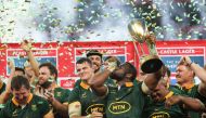 South Africa's flanker Siya Kolisi (C) lifts the trophy while kissing his wrist as he celebrates with his teammates after they won the Rugby Championship following their match between South Africa and Argentina at Mbombela Stadium in Mbombela on September 28, 2024. (Photo by PHILL MAGAKOE / AFP)