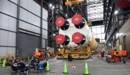 Workers take a break inside the Vehicle Assembly Building next to the Artemis II core stage of NASA's Space Launch System at the Kennedy Space Center in Florida on September 28, 2024. Photo by Gregg Newton / AFP.