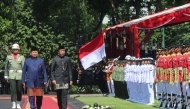 Indonesia's newly sworn-in Prabowo Subianto (L) and his predecessor Joko Widodo (2L) review the troops during the presidential inauguration ceremony at the Presidential Palace in Jakarta on October 20, 2024. (Photo by Gyl Batara / AFP)
 