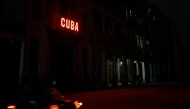 A sign enlightens a blacked out street during the second day of the nationwide blackout in Havana October 19, 2024. Photo by ADALBERTO ROQUE / AFP.