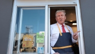 Republican presidential nominee, former US President Donald Trump answers questions as he works the drive-through line as he visits a McDonald's restaurant on October 20, 2024 in Feasterville-Trevose, Pennsylvania. (Photo by Win McNamee/Getty Images via AFP)