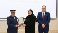 Legal Advisor to Minister of Interior and General Supervisor of the Police Academy Major General Dr. Abdullah Yousef Al Mal (left) honouring CEO of the Hour and Hour Programme Tamani Al Yafei (centre) at the event.