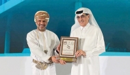 Minister of State and President of Qatar National Library H E Dr. Hamad bin Abdulaziz Al Kawari (right) during the award presentation.