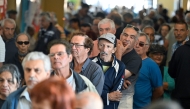 People queue to vote during the presidential runoff election in Montevideo on November 24, 2024. (Photo by Santiago Mazzarovich / AFP)
