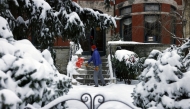 Langley Bowers shovels the snow off his stoop on Capitol Hill on January 6 as a major snowstorm blankets the city. (Photo by Robb Hill for The Washington Post)

