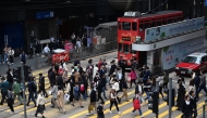 People cross an intersection in the Central business district in Hong Kong. AFP file photo.
