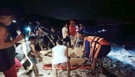 This handout photo taken February 27, 2025 and released by the Philippine Coast Guard February 28, shows coast guard personnel and rescuers placing recovered bodies of two Russian divers on stretchers near Verde Island, in Batangas City, south of Manila. Photo by Handout / Philippine Coast Guard (PCG) / AFP
