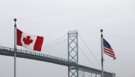 Trucks cross the Ambassador Bridge between Windsor, Canada and Detroit, Michigan on the first day of President Donald Trump's new 25% tariffs on goods from Canada and Mexico on March 4, 2025 in Windsor, Canada. (Photo by Bill Pugliano/Getty Images via AFP)
