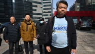 Jiang Hui (R), a relative of a passenger on board the missing Malaysia Airlines flight MH370, stands with others with missing loved ones as he speaks to the media after a meeting in Beijing on March 8, 2025, on the 11th anniversary of the flight's disappearance. (Photo by Pedro Pardo / AFP)
