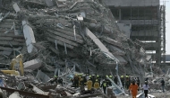 Rescue teams are seen at a construction site where a building collapsed in Bangkok on March 28, 2025, after an earthquake. Photo by Lillian SUWANRUMPHA / AFP