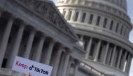 File: A person holds a sign during a press conference about their opposition to a TikTok ban on Capitol Hill in Washington, DC on March 22, 2023. (Photo by Brendan Smialowski / AFP)
