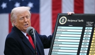 US President Donald Trump holds a chart as he delivers remarks on reciprocal tariffs during an event in the Rose Garden entitled 