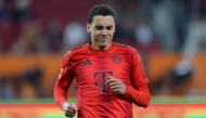 Bayern Munich's German midfielder #42 Jamal Musiala reacts after sustaining an injury during the German first division Bundesliga football match between FC Augsburg and FC Bayern Munich in Augsburg, southern Germany, on April 4, 2025. (Photo by Alexandra BEIER / AFP) 