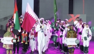 Beach volleyball star Cherif Younousse carries the Qatar flag during the opening ceremony.