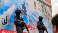 Members of Huthi-affiliated security forces stand guard during a rally in solidarity with Palestinians in the Gaza Strip and in condemnation of US strikes, in Yemen's Huthi-controlled capital Sanaa on April 11, 2025. (Photo by Mohammed HUWAIS / AFP)

