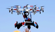 A flying vehicle makes its debut flight in front of visitors at the 2025 Osaka-Kansai Expo on Monday. Photo by The Japan News via Washington Post

