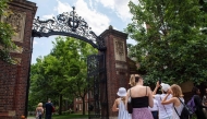 (Files) People take photos by the entrance to Harvard Yard in Cambridge, Massachusetts, on June 29, 2023. (Photo by Joseph Prezioso / AFP)
