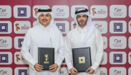 QBF President Mohammed Saad Al-Mughaiseeb and Chief Development and Asset Management Officer of Qatari Diar Fahad Abdullatif Al Jahrami pose for a picture after the signing ceremony.

