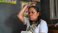 Jenita Aguilar, a member of the family that Pope Francis visited in 2015, demonstrates the Popes blessing gesture during an interview with AFP at her home in Tacloban City, province of Leyte on April 22, 2025, a day after the Pope's death. (Photo by Jam STA ROSA / AFP)