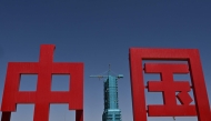 The Long March-2F carrier rocket, carrying the Shenzhou-20 spaceship, is seen encased in blue scaffolding on the launch pad a day before the launch of the Shenzhou-20 mission, at the Jiuquan Satellite Launch Centre in the Gobi desert in northwest China on April 23, 2025. Photo by Pedro Pardo / AFP