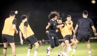 Al Sadd's Akram Afif (centre) trains with teammates.