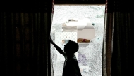 A man shows the shattered window of a house after cross-border shelling in Arnia town near the border area in India's Jammu region on May 10, 2025. (Photo by Money SHARMA / AFP)
