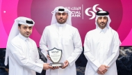 Officials pose for a group photo with the award.