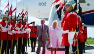 Britain's King Charles III and Britain's Queen Camilla are greeted by an honour guard after arriving at Macdonald-Cartier International Airport in Ottawa, Canada, May 26, 2025. (Photo by Victoria Jones / POOL / AFP)
