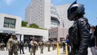Protesters stand off with National Guard soldiers and police outside the Metropolitan Detention Center, MDC on June 08, 2025 in Los Angeles, California. (Photo by SPENCER PLATT / GETTY IMAGES NORTH AMERICA / Getty Images via AFP)
