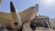 This handout taken and posted on the X (formerly Twitter) account of the Central Industrial Security Force (CISF) On June 12, 2025 shows the back of AN Air India plane after it crashed in a residential area near the airport in Ahmedabad. (Photo by Handout / CENTRAL INDUSTRIAL SECURITY FORCE (CISF) / AFP) 