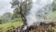 This handout photograph taken on June 15, 2025 and released by the State Disaster Response Force (SDRF) of India's Uttarakhand state shows smoke billowing from the site of a chopper crash near Gaurikund. (Photo by Uttarakhand's State Disaster Response Force (SDRF) / AFP) 