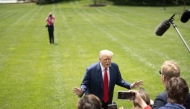US President Donald Trump speaks to journalists near Marine One on the South Lawn of the White House on Monday. (Photo by Tom Brenner/For The Washington Post)