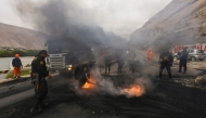 Police officers clear a road that was blocked by miners during a protest at kilometer 782 of the Pan-American Highway South, near the Ocona Bridge, in the province of Camana, Arequipa Department, southern Peru, on July 11, 2025. Road unblocking operations in southern Peru left one dead and 20 injured on Friday, including seven officers, amid protests by informal miners who reject government demands to legalize their activity, authorities reported. (Photo by Juan Jose SANTY / AFP)