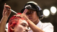 A barber gives a model a haircut during the World Barber Classic at Korakuen Hall in Tokyo on July 14, 2025. (Photo by Philip FONG / AFP)