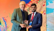 Director of the Survey Department at the Ministry of Municipality Ali Al-Marzouqi (right), receiving the award.