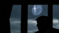 The profile of US President Donald Trump is pictured in backlight as he speaks with European Commission President Ursula von der Leyen (2nd R) during a meeting, in Turnberry south west Scotland, on July 27, 2025, on the third day of his visit to the country, since his second tenure as President began. Photo by Brendan SMIALOWSKI / AFP
