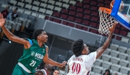 Qatar's Brandon Datrill Goodwin (centre) scores a field goal.