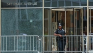 A New York City Police (NYPD) officer stands outside the 345 Park Avenue building, the scene of last night's deadly shootings in Midtown Manhattan in New York on July 29, 2025. (Photo by TIMOTHY A. CLARY / AFP)
